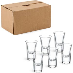 A box containing six clear 15ml shot glasses, arranged in front of it.