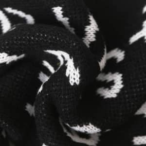 Acrylic fibres scarf featuring a black and white design, showcasing a textured knit pattern.