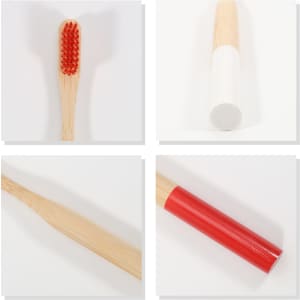 A colourful bamboo toothbrush with a large round handle featuring red bristles, white and red sections.