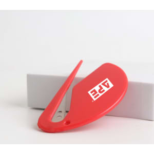 A red letter opener with a sleek design and a logo on the side, resting on a grey box.