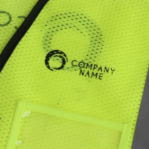 A high-visibility yellow vest with reflective tapes and functional pockets, featuring a logo.