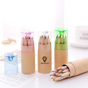 A set of coloured pencils in three transparent containers: pink, green, and blue, all with a brown base.