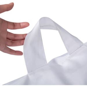 A hand holding a white bag with a handle, showcasing the bag's design and stitching details.