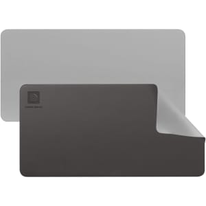 A PU leather desk mat featuring grey and black colours, with a logo in the corner and a smooth finish.