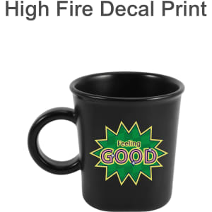 A black ceramic coffee mug with a handle and a colourful graphic featuring the word "GOOD". It has a logo.