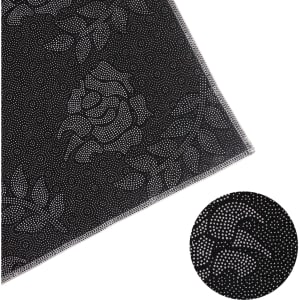 A black plush logo mat featuring a subtle rose pattern, bordered with a stitched edge. It includes a logo.