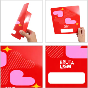A custom-shaped paper fan in red featuring pink heart designs and a logo. The fan has no handles.