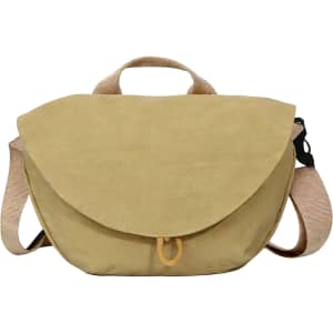 A casual crossbody bag in a soft yellow shade, featuring a flap closure and adjustable strap. It has a logo.
