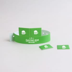A green PVC wristband with two tabbed attachments, featuring a logo and icons.