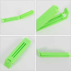 A green plastic clip for sealing small food bags, designed with an open and closed position for easy usage.