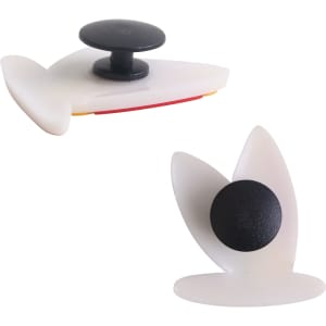 Two white clog shoe charms with a black button, featuring unique shapes and designs.