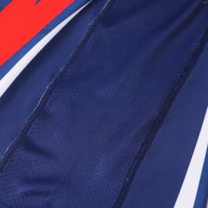 A long-sleeved T-shirt in navy blue with contrasting red accents and a logo, featuring a breathable fabric design.