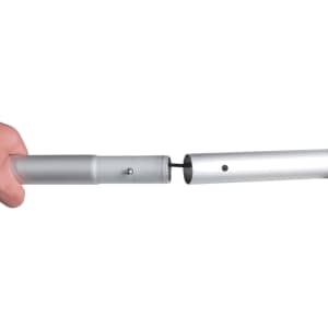 A hand holds two metallic poles, one connecting to the other, showcasing a joining mechanism for a display structure.