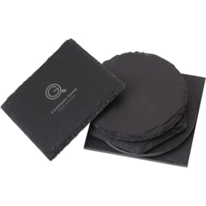 A set of black slate coasters stacked together, featuring a logo on one coaster.