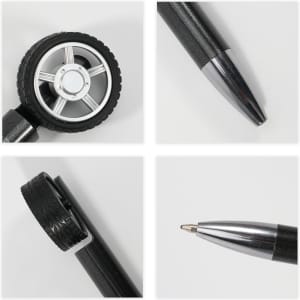 A Fidget Spin Tire Shape Pen featuring a black tyre design and a shiny silver pen tip. Includes a logo on the pen.