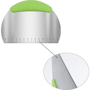 A stainless steel flour cutter with a green silicone handle and measurement markings along the edge.