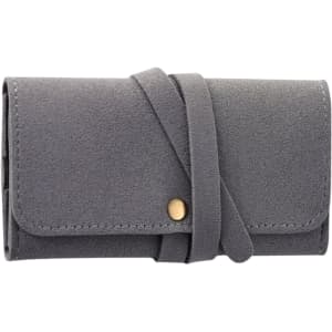 A grey synthetic leather jewellery bag with a fold-over design and a decorative strap closure.