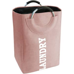 A pink laundry basket with a handle, featuring a textured fabric and a black interior. It has a smooth metallic handle.