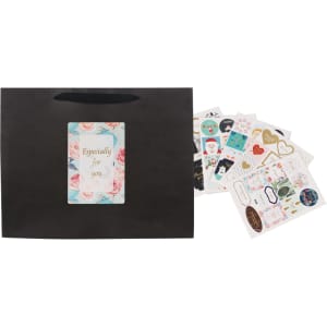 A large black paper bag with a fabric handle, accompanied by various decorative stickers.