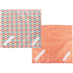 Reusable food wraps in patterned designs, featuring colours like orange, blue, and red. The wraps have a logo on one side.