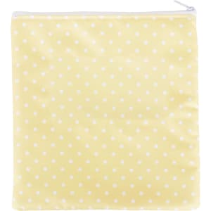 A reusable food pouch in a cheerful yellow with white polka dots and a zippered closure.
