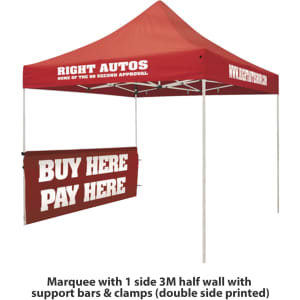 A red marquee with a half wall, featuring support bars and clamps, includes printed branding.
