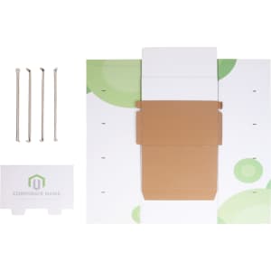A self-assembly cardboard floor display in white and green, with a brown box, assembly tools, and a branded base.