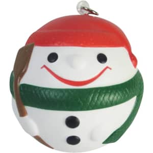 A cheerful snowman keyring in white, green, and red, with a smiling face and a small shovel accessory.
