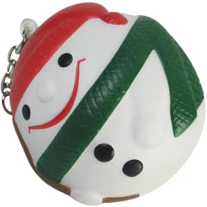 A keyring featuring a smiling snowman design in white, green, and red, with black accents and a metal chain.