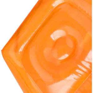 An inflatable chair in vibrant orange, featuring a smooth surface and rounded edges. It has a logo visible on it.