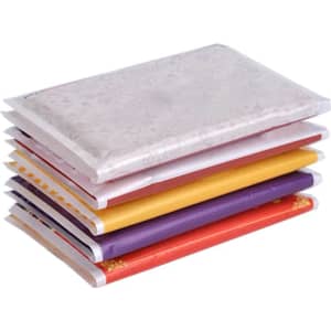 A stack of coloured pocket tissues in red, yellow, purple, and white packaging. The top tissue features a patterned design.