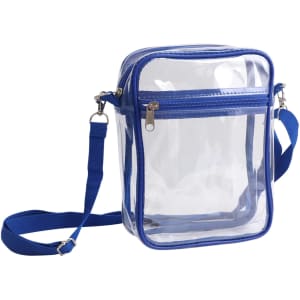 A clear crossbody tote bag with a blue zipper closure and an adjustable blue strap. Features a logo on the front.