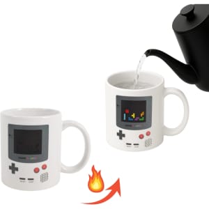 A heat-sensitive colour changing mug in white, resembling a retro gaming console, with a pouring kettle above.