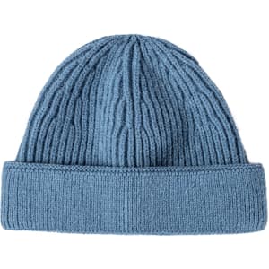 A round beanie in a soft blue shade with a ribbed texture and a folded cuff. It features a logo on the side.