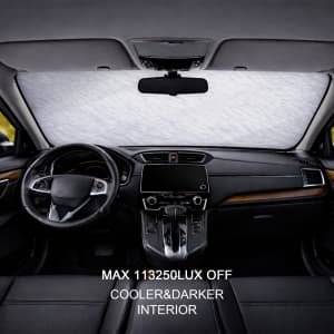 An aluminum snow cover inside a car, featuring a light silver colour, with dark leather seats and dashboard.