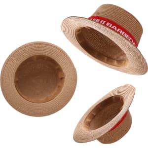 A straw hat with a wide brim and a ribbon band. The hat is natural tan colour with a red ribbon accent.