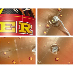 An inflatable beer bottle in vibrant red and gold, featuring detailing and a valve for inflation.