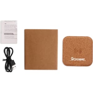 A square cork wireless charger in tan, accompanied by a USB cable and a small instruction booklet.