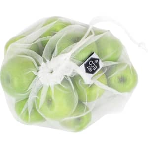 A translucent white produce bag containing several green apples, gathered at the top with a drawstring.