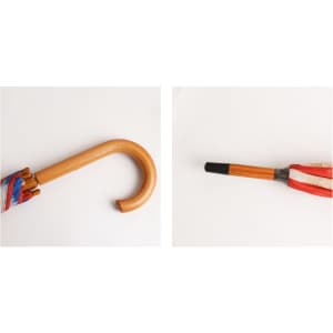 A wooden umbrella with a curved handle, featuring a colourful canopy and a black tip. The product has branding on it.