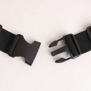 A black running belt featuring adjustable straps and a sturdy buckle for secure fastening.
