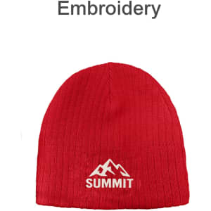 A red cable knit beanie featuring an embroidered mountain logo.