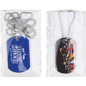 Two dog tags in packaging, one blue with a logo and the other multi-coloured featuring a graphic design. Both come with chains.