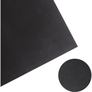 A black diatomite floor mat featuring a textured surface and a circular inset showing the material's pattern.
