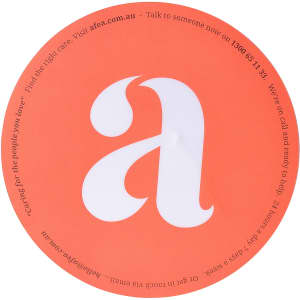 A round orange mouse mat featuring a large white letter 'a' and a small logo.