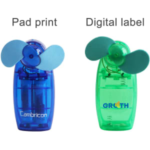 A transparent blue and green handy fan with blue blades, featuring branding on each unit.
