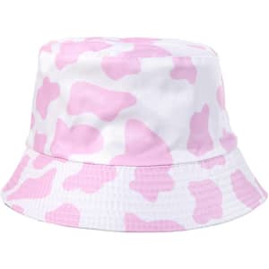 A pink and white cow print bucket hat with a wide brim and soft fabric. Features a branding logo on the side.