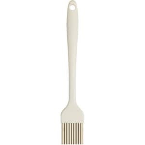 A silicone basting brush in cream, featuring a long handle and a brush head with flexible bristles.