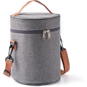 A cylindrical lunch bag in grey fabric with a brown shoulder strap and zip closure, featuring a logo.