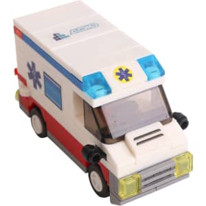 A toy ambulance building block set in white, red, and blue, featuring a detailed window and wheels.